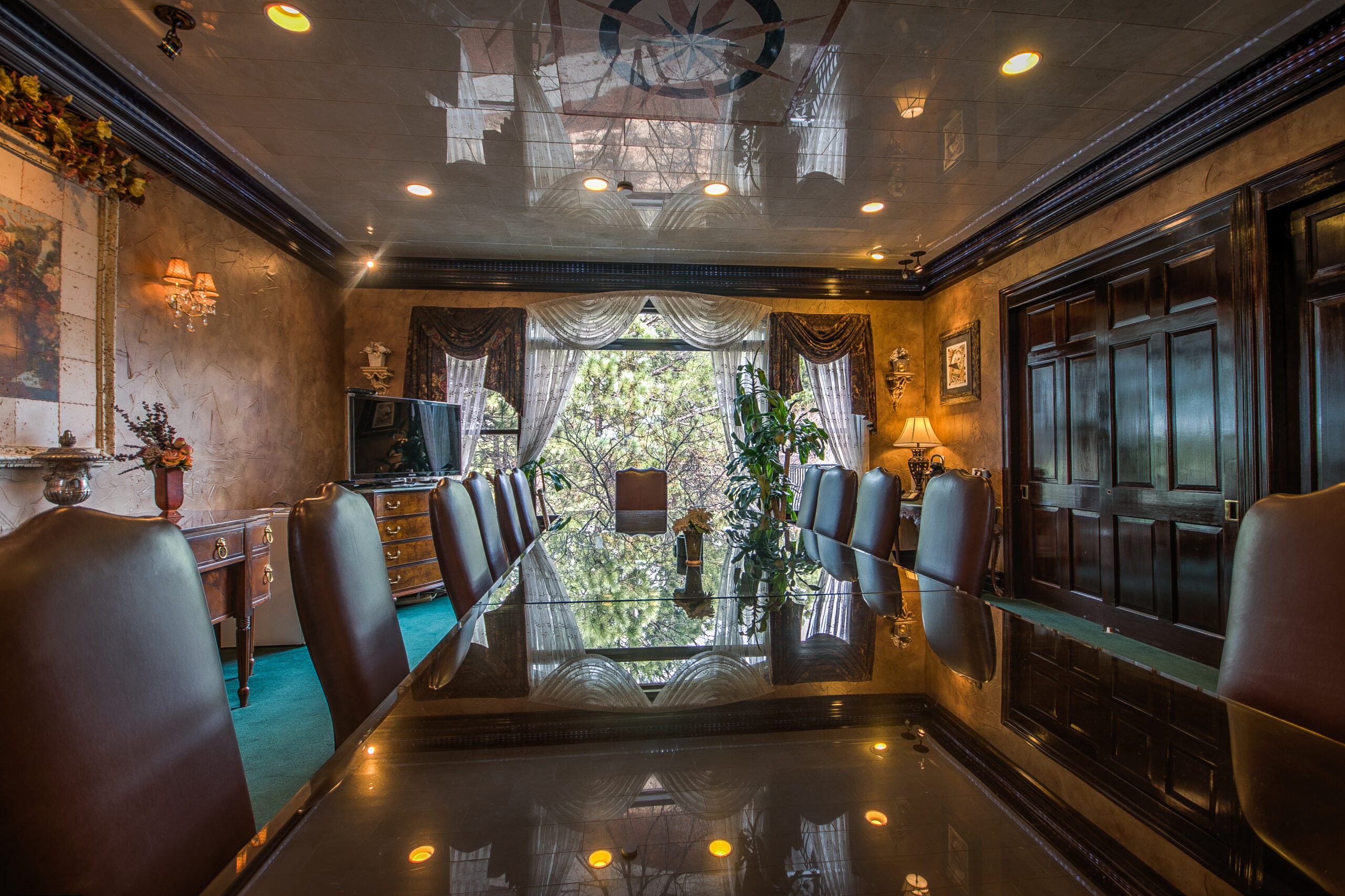 Conference room at 7035 Campus Drive with a long polished table and leather chairs