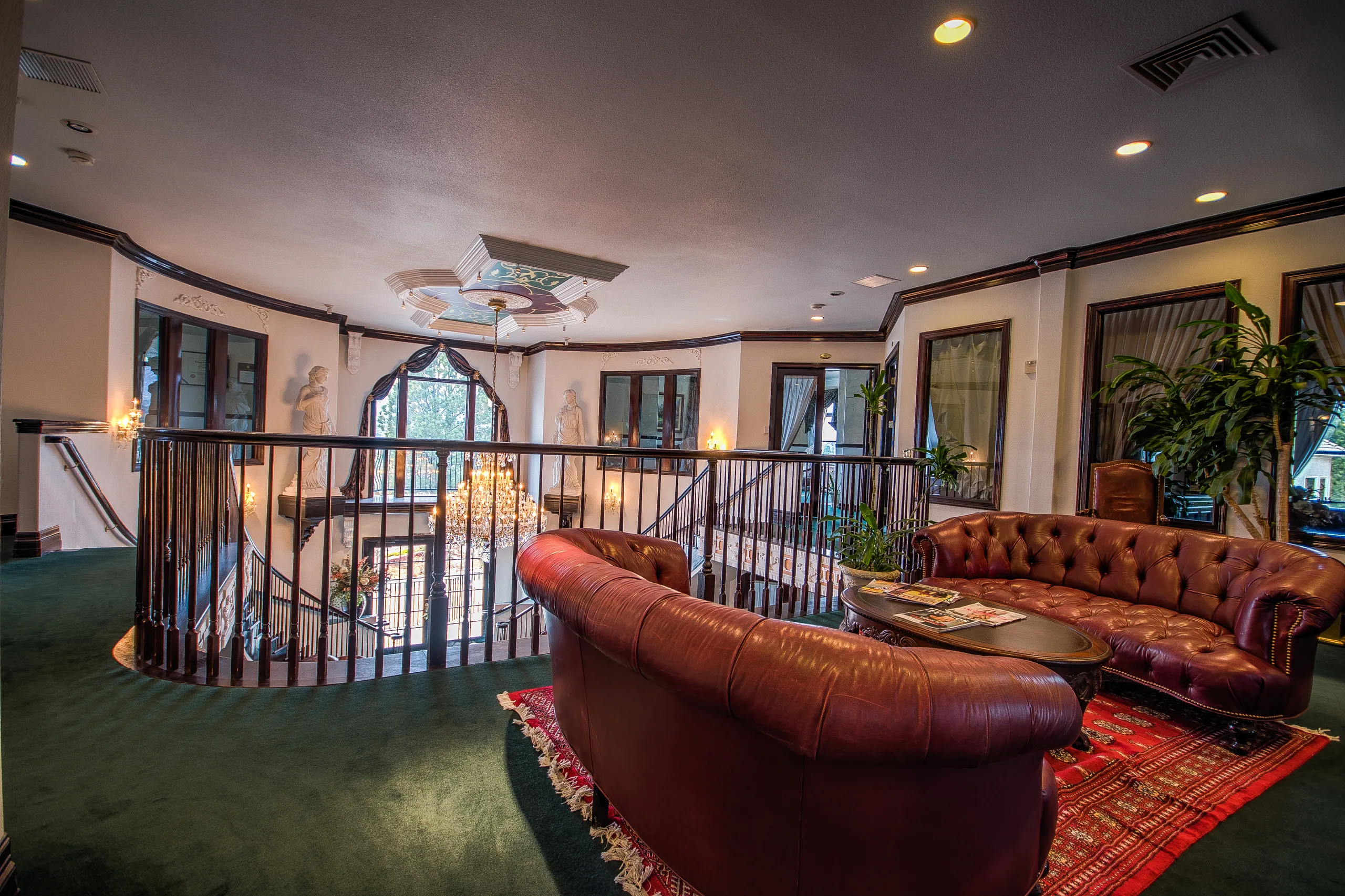 Mezzanine lounge at 7035 Campus Drive with leather chesterfield sofas overlooking the atrium